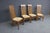 Set of four Mission Oak dining chairs by L. & J.G. Stickley. Made of solid oak with tall slat backs and upholstered seats....