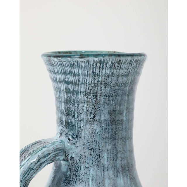 Hand-thrown in the celebrated Burgundy village of Accolay, this tall stoneware pitcher epitomises French studio ceramics...