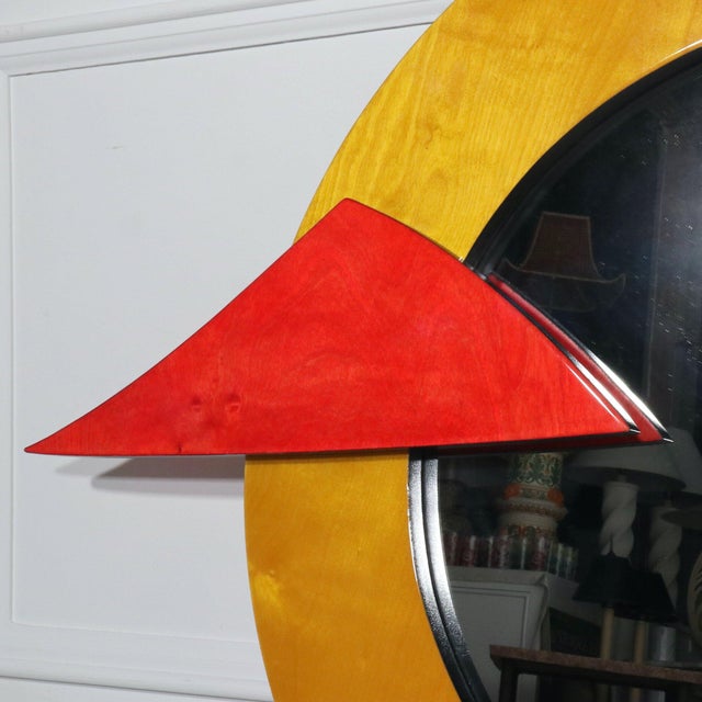 Memphis framed abstract pop art wall mirror, circa 1980s. Lacquered wood in shades of red green blue and purple....