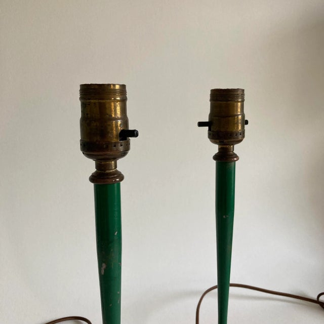 A pair of vintage, metal lamps in a painted, hunter green finish with metal accents in a brass-tone/ color. Each lamp has...