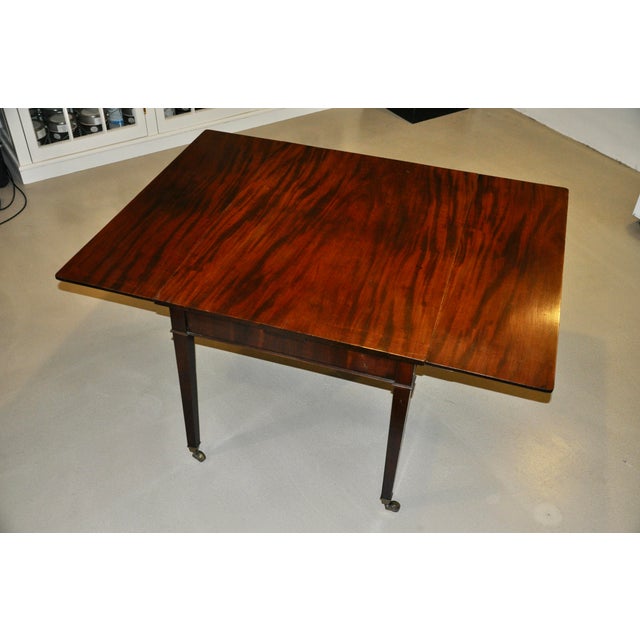 Perfect for small spaces, here we have a handsome Georgian style mahogany dining table with square tapered legs raised on...