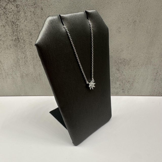 This charming diamond snowflake necklace in 10kt white gold features 0.10 carats total weight of natural GH SI round and...