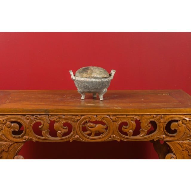 A Chinese Han Dynasty tripod incense burner with removable lidded top, circa 202 BC-200 AD. Featuring a circular shape...