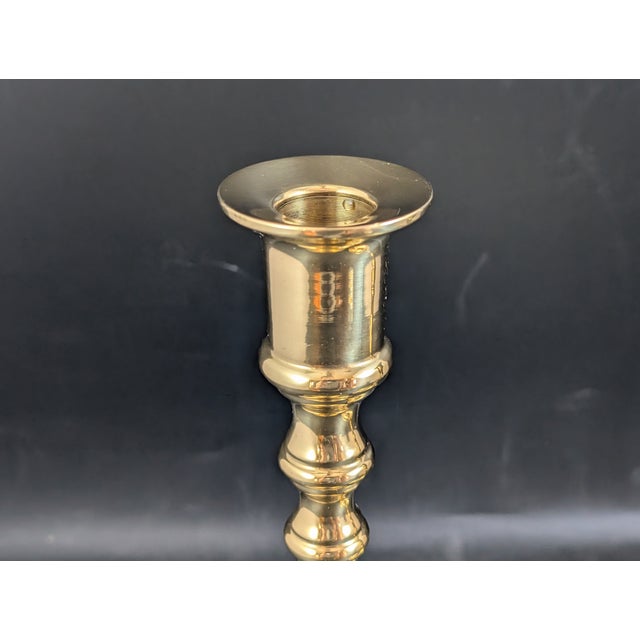 Lovely pair of brass candlesticks made in Portugal. Mirrored finish, there are a few scratches around the top.