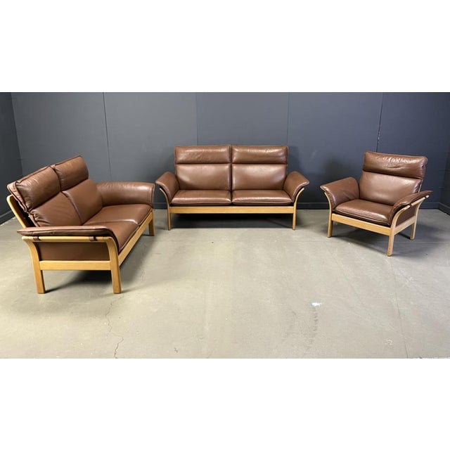 Model 'scala' sofa set consisting of 2 two seater benches and an armchair. Solid beech wooden frames with brown chocolate...