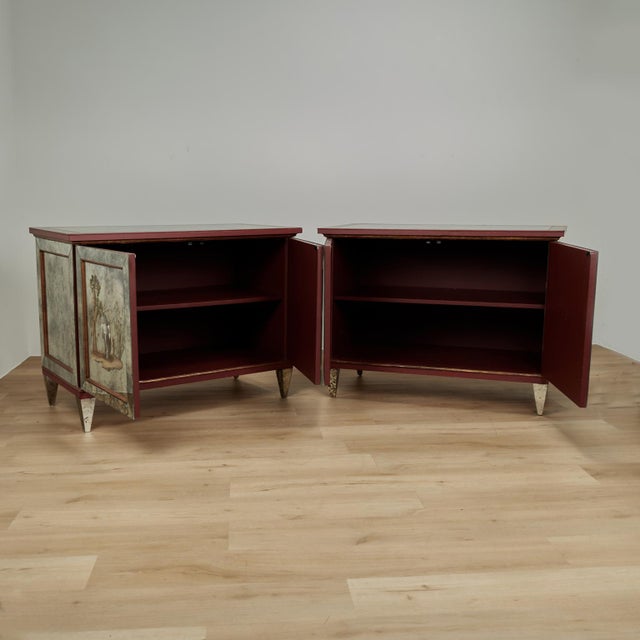 Rare and remarkable pair of Italian art deco cabinets featuring distressed mirrors all around, tops bordered with floral...