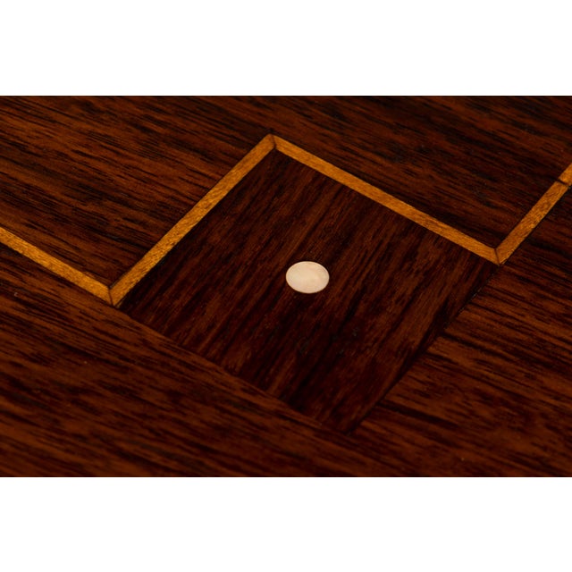 A distinguished 1930s Parisian Art Deco dining table in rosewood, in the taste of Jules Leleu, sourced in Paris, France....