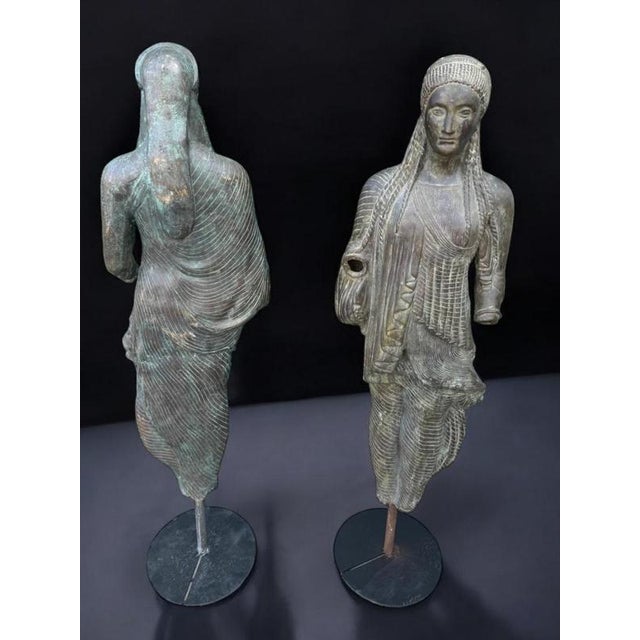 Title: Pair of Bronze Sculptures of the Kore of Peplos - Early 20th Century with Modern Bases Product Overview: This...