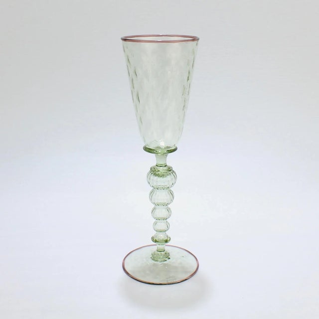 A large Alan Goldfarb Venetian style goblet. In green glass with a light purple applied lip and footrim. Alan Goldfarb was...