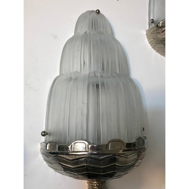 A stunning pair of French Art Deco "waterfall" sconces from the 1930s signed by Marius Ernest Sabino (1878-1961). The...