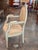 An 18th century Swedish armchair in worn pale blue-green paint, the oval back with a laurel-carved frame and rosette crest...