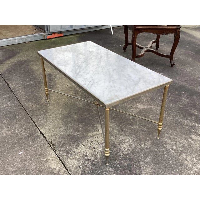 This is a classic French Louis XVI style coffee table. Made of quality brass, the base features fluted legs and an elegant...