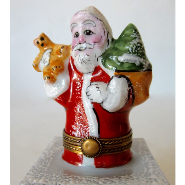 Limoges, France, hand-painted with brass surround details is this porcelain, enameled Santa Claus Trinket box of Santa...