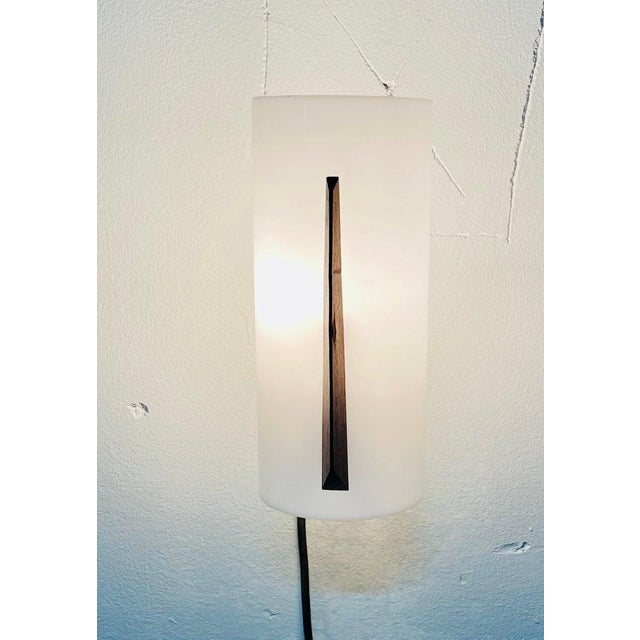 Elegant wall lamp made in Italy in the 1960s, a distinctive example of the vintage modernist style of the time. The...