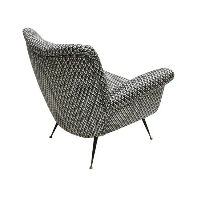 Armchair designed by Gigi Radice for Minotti with solid wood structure and metal legs. Upholstery in cotton with...