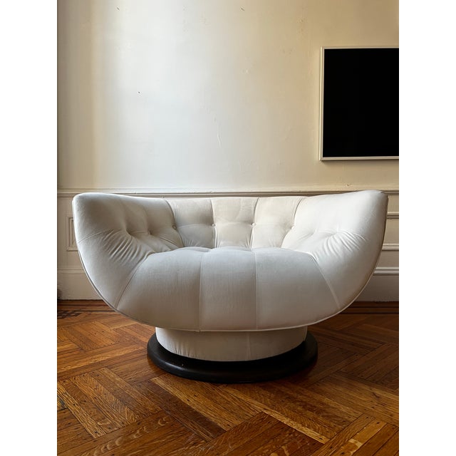 This Adrian Pearsall monumental chair features a substantial walnut base with 360-degree swivel function and has been...