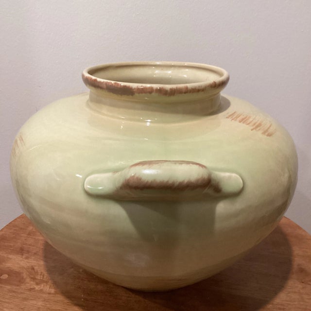 Vintage ceramic glazed cream color vase with two small handles.Part of large collection of cream vase. Good for your home...