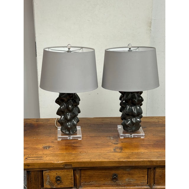 Design Plus Gallery presents a Pair of Meteoric Table Lamps. Each lamp has a sculptural ceramic base with a charcoal glaze...