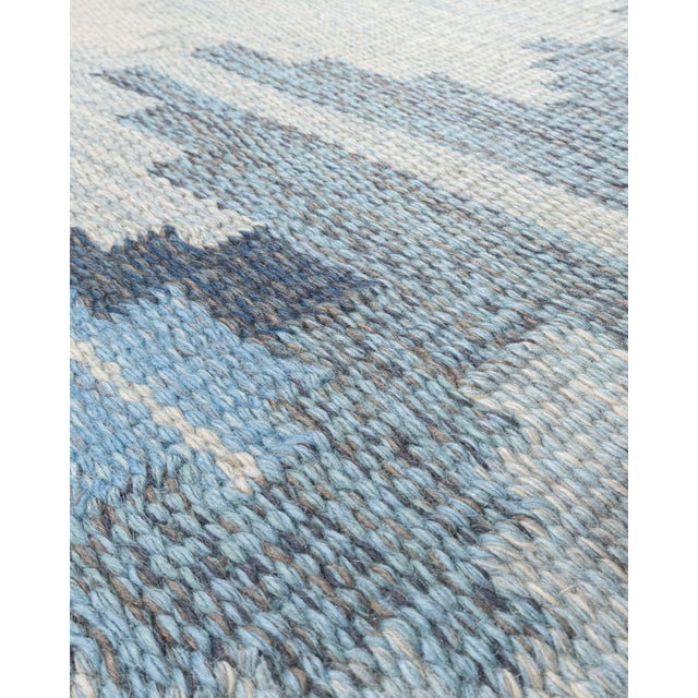 A delightful mid-century circa 1960 Scandinavian hand knotted rug with wonderful colors woven into the design. Colors:...