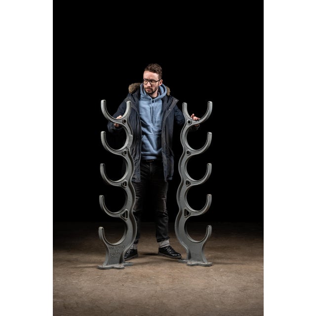Matching pair of freestanding cast iron pipe racks, each constructed with five graduated U-shaped cradles designed to...