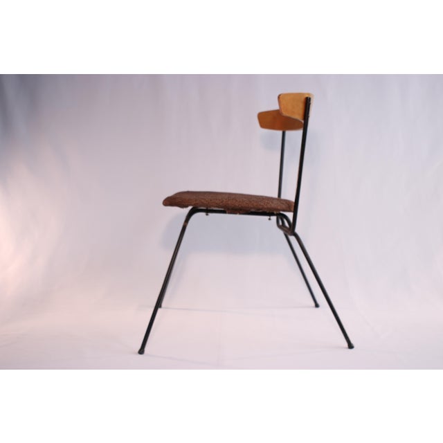 Designed by Clifford Pascoe with inspiration from a model by Paul McCobb, this chair features a sculpted walnut backrest...