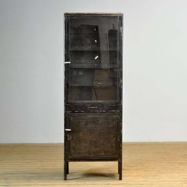 Medicine cabinet from the 1950s, manufactured in former Yugoslavia. This cabinet is made of iron and glass, creating a...