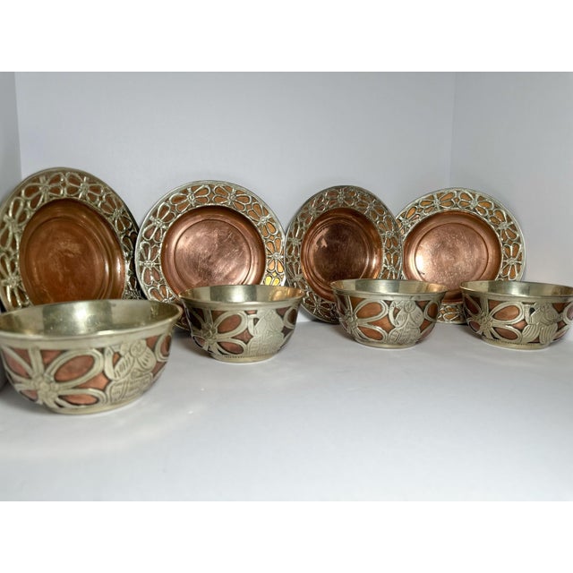 An eight‑piece serving set hand‑engraved in the Middle East during the 1920s–30s. Warm copper forms the base while a...