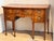 Regency period mahogany sideboard with a bowfront form and richly figured veneer. The central drawer is flanked by banks...