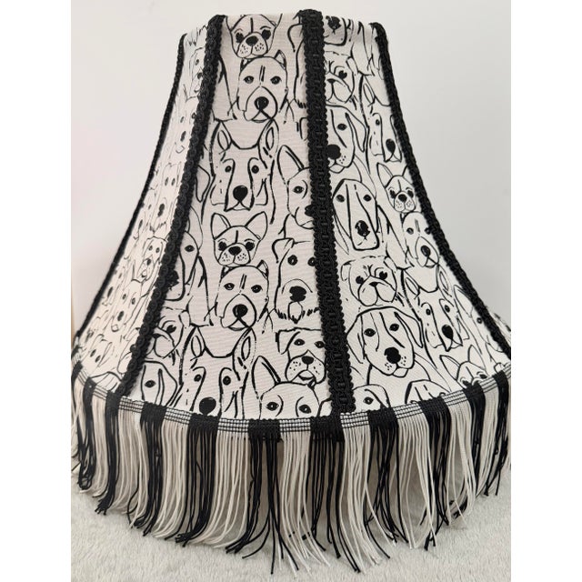 Decorative loveable lampshade crafted from a striking black-and-ivory illustrated textile featuring expressive canine...
