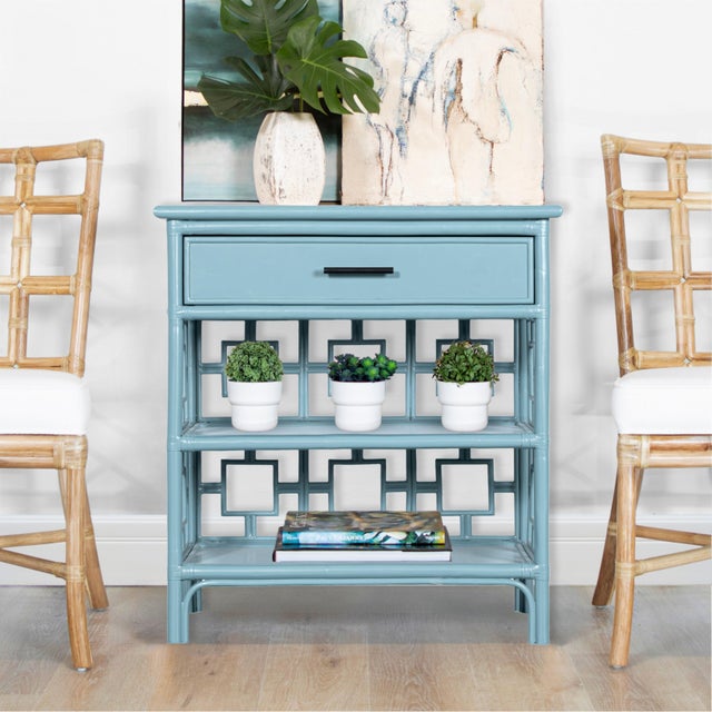 Classically styled, this end table features a Rattan frame with leather bindings. The intricate rattan detail is hand...