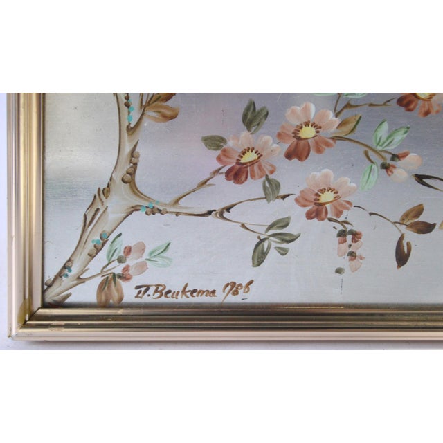 Chinoiserie style mirror with silver leaf eglomise panels depicting various nature scenes of flora and water falls. Panels...