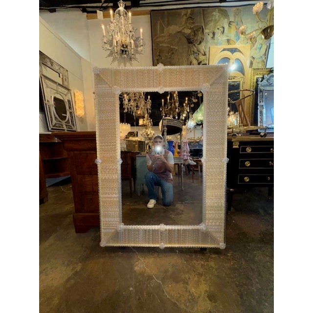 The Modern Murano Twist Glass Rod Mirror in Light Gold features a sleek and contemporary design, perfect for adding a...