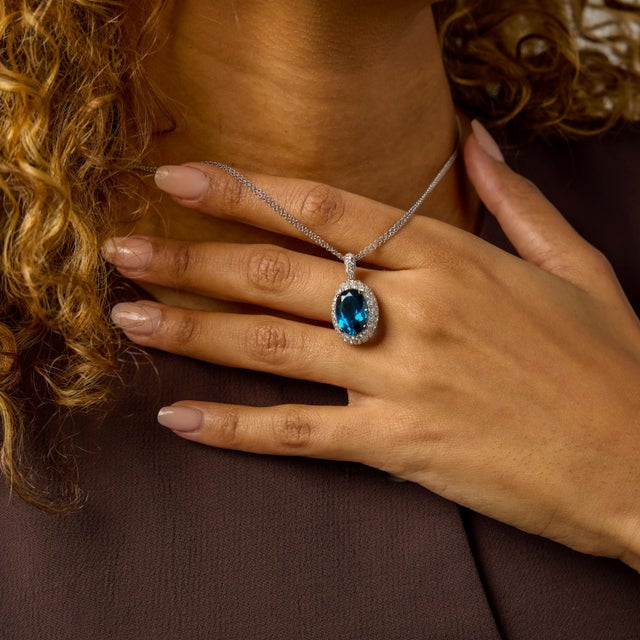 This vintage Italian topaz and diamond pendant necklace is a refined composition of color, brilliance, and graceful...