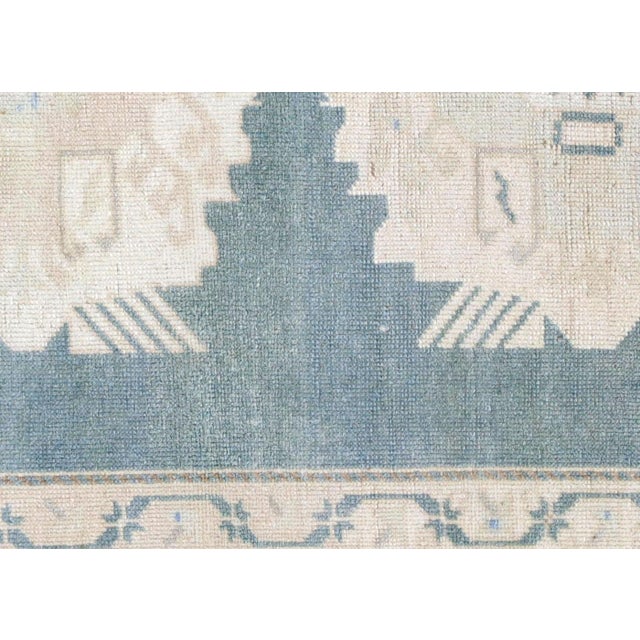 This authentic Oushak weaving originates from Turkey's storied textile heritage, crafted entirely by hand using wool yarns...