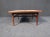 This vintage walnut coffee table is full of Mid-Century style, with a surface of contrasting white panels. Please confirm...