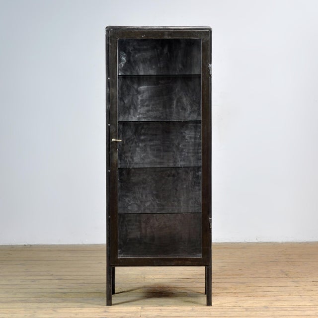 Medicine cabinet from the 1920s. This cabinet is made of iron and glass, creating a rugged industrial look. The cabinet...