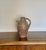 Rustic vintage clay vessel with a charming primitive design, crafted from terracotta with a natural earthy finish. Perfect...