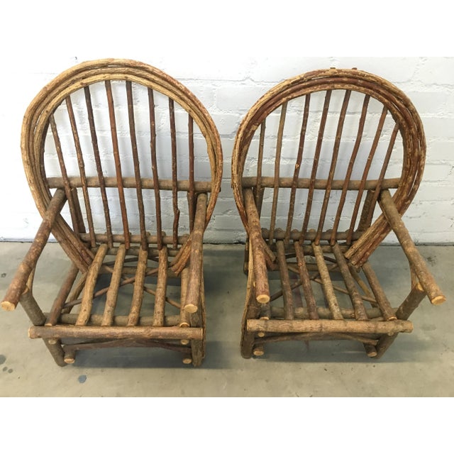 This pair of rustic Adirondack chairs boasts a sturdy wood frame (believed to be a combination of willow and hickory)...