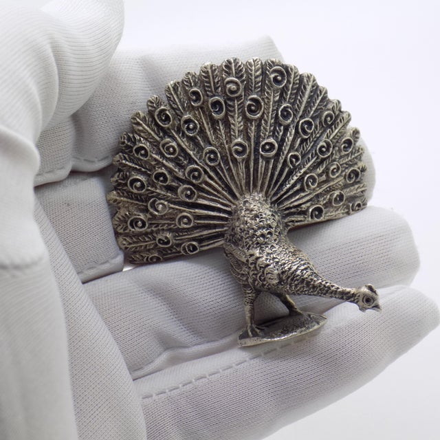 Striking vintage sculpture depicting a peacock, handmade in Italy between the 1940s and 1950s in genuine Italian silver....