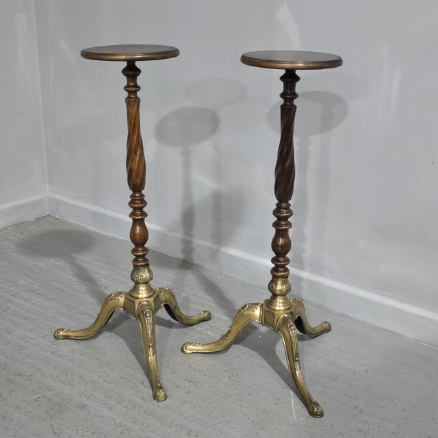 A very good pair of twisted mahogany torchere stands with brass three leg base, in overall excellent condition.