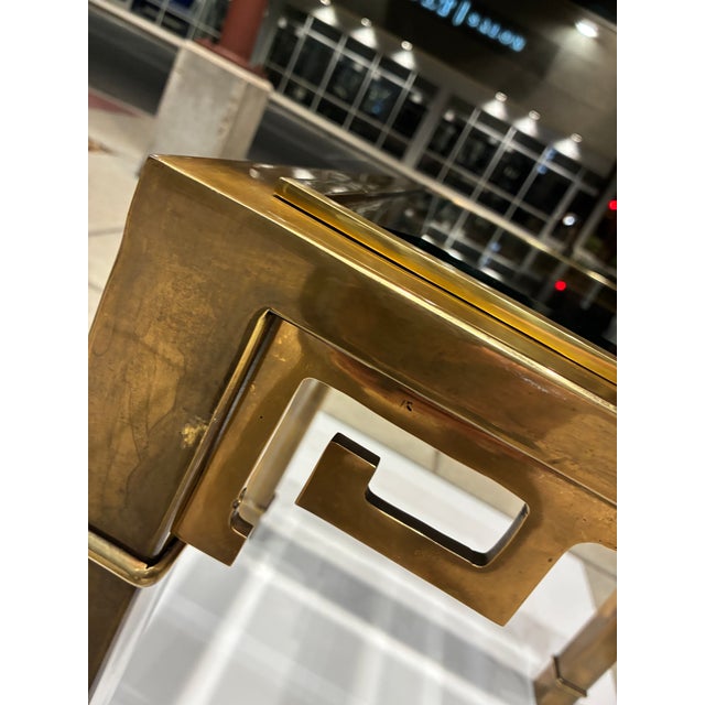 Iconic brass end table with chamfered in-set glass top, manufactured in Italy for Mastercraft, circa 1970s.