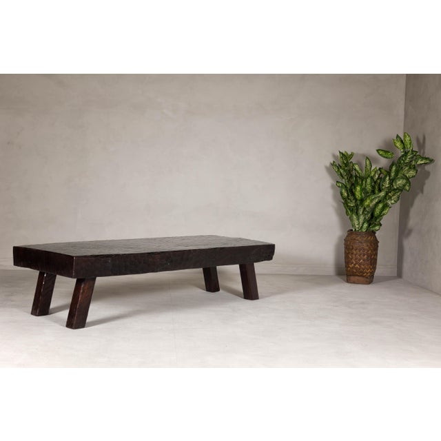 A rustic chunky coffee table with honeycomb patterns and dark patina. This rustic coffee table is a true testament to...