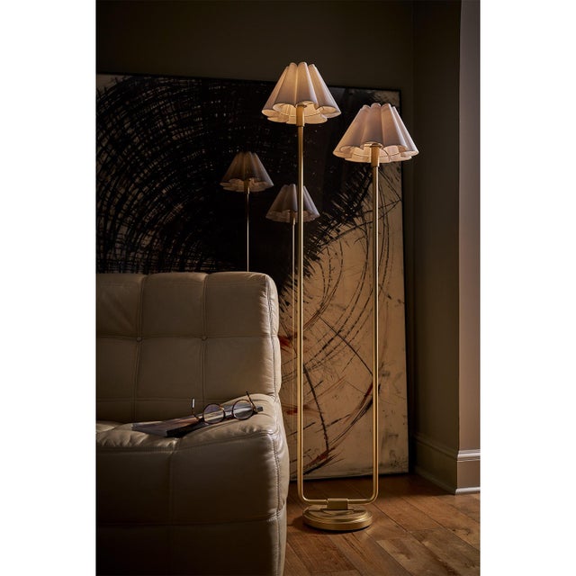 The Polly Floor Lamp exudes timeless elegance with its two scalloped shades, casting a soft, comforting glow that enhances...