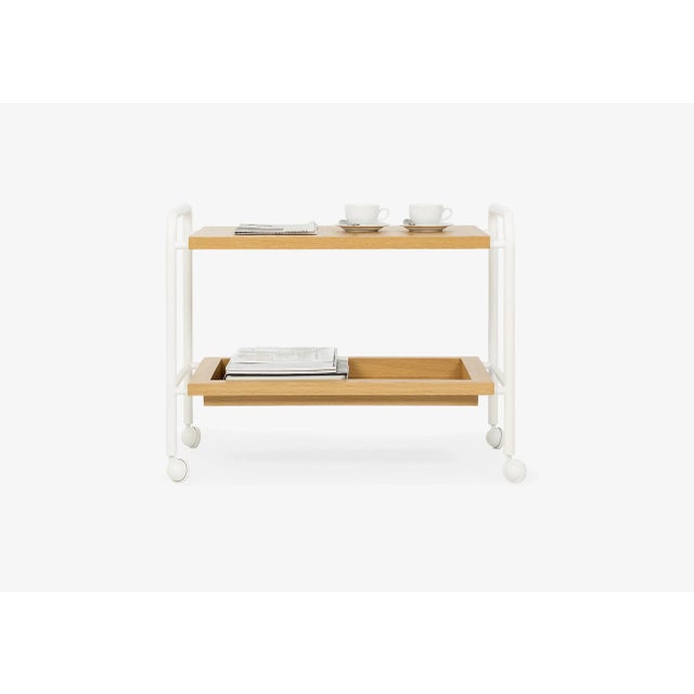 Side table composed of 1 lacquered steel structure with wheels and 2 tops in solid oak wood and MDF veneered with natural...