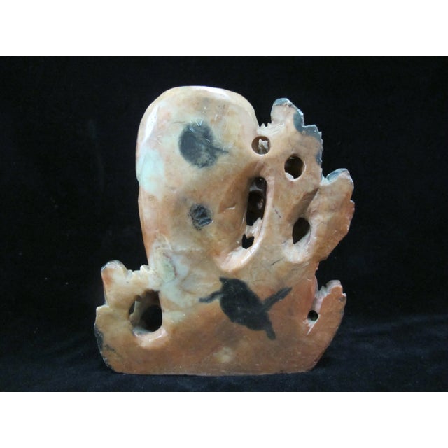 Early 20th-century Chinese hand-carved soapstone foo dog sculpture featuring an intricate double vase and brush washer...