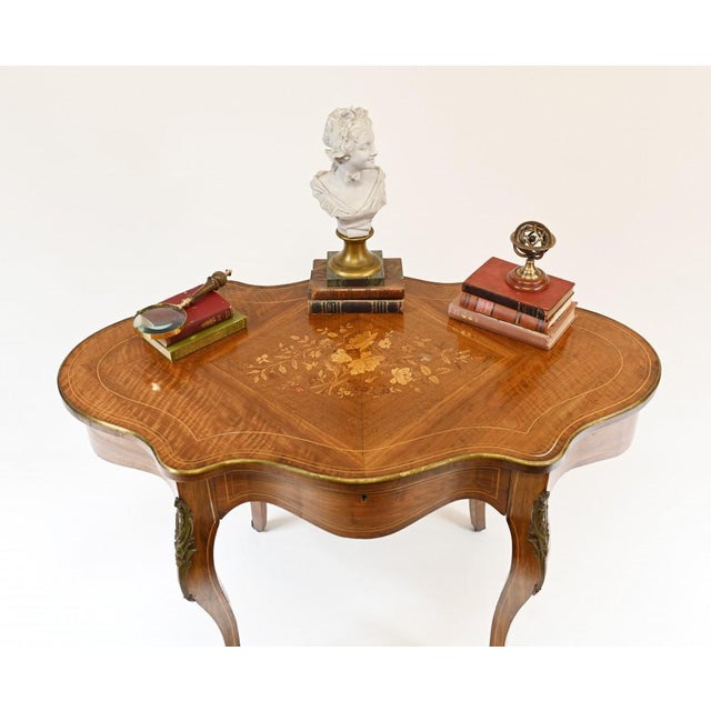 Elegant antique French desk or centre table. Lovely shaped top with elegant top on cabriole legs. Original ormolu mounts....