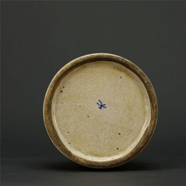 Add a touch of rustic, folk-art charm to your space with this charming blue and white porcelain jar. Featuring a...