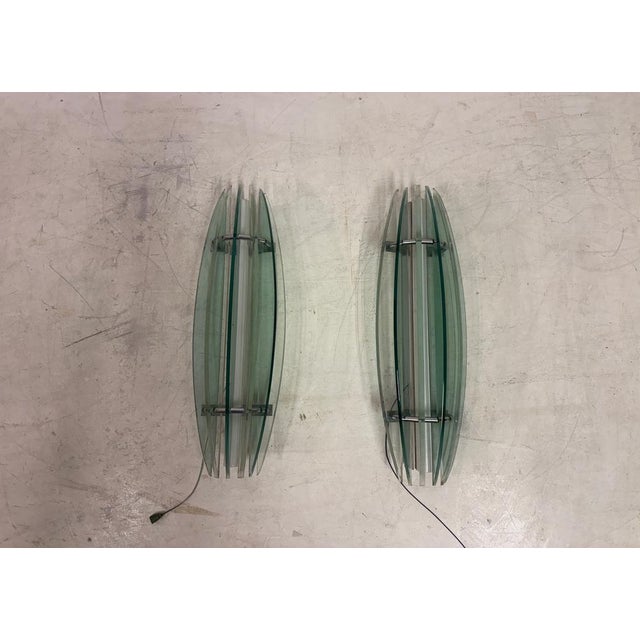 A striking pair of large wall lights by Veca, defined by their sculptural, vertically layered glass construction and...
