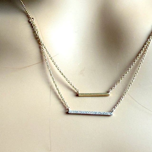 Elevate your jewelry collection with this chic 14K Yellow and White Gold Diamond Bar Layered Necklace, perfect for...