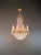 A antique crystal chandelier in the style of the French Empire Revival, dating from around 1920. Its imposing height,...